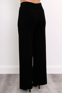 Rear view of onyx casual trousers, highlighting a comfortable flat waistband and pocket-free back panel design.