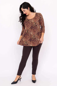 Woman looking down and holding hem of leopard print bamboo 3/4 sleeve tunic