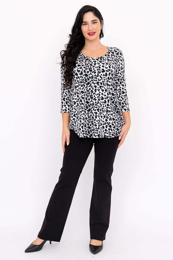 Full body view of model in snow leopard print 3/4 sleeve top and black pants