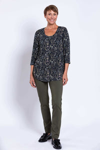 Woman standing in Jazz 3/4 bamboo top, forest floral, shown from the front