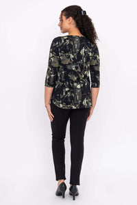 Back view of a woman wearing an abstract black and olive print 3/4 sleeve top