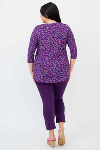Back view of woman in purple floral 3/4 sleeve bamboo top and purple pants