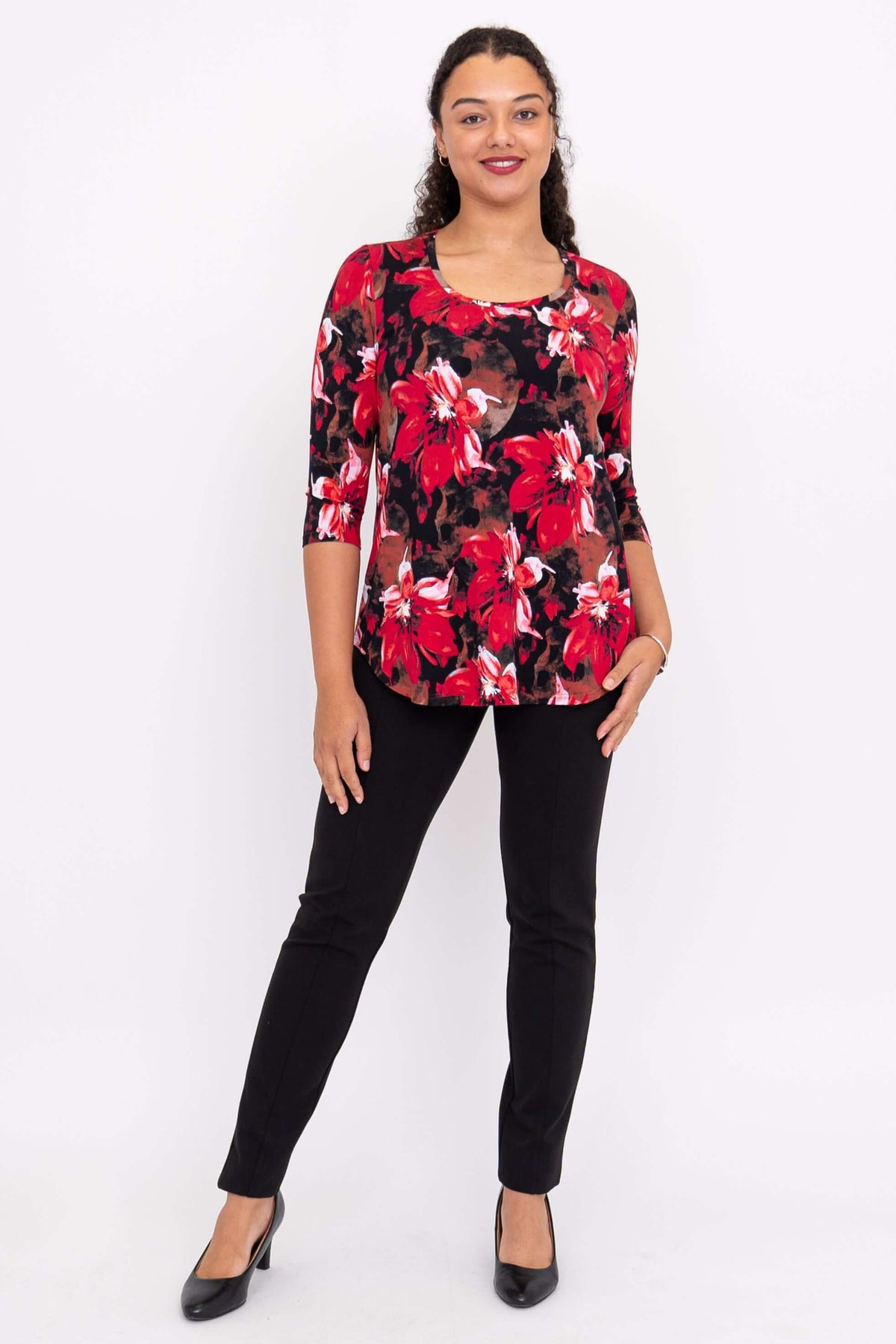 Another front view of a model in a vibrant red floral 3/4 sleeve bamboo top