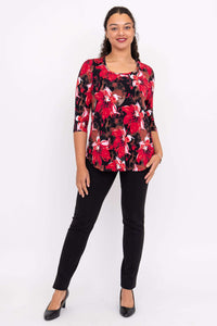 Another front view of a model in a vibrant red floral 3/4 sleeve bamboo top