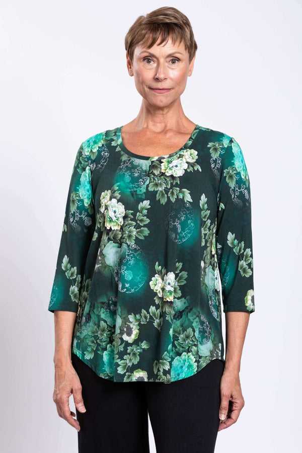 Woman wearing a green floral 3/4 sleeve bamboo top, close-up front view