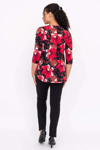 Back view of a model wearing a red floral 3/4 sleeve bamboo top with black pants