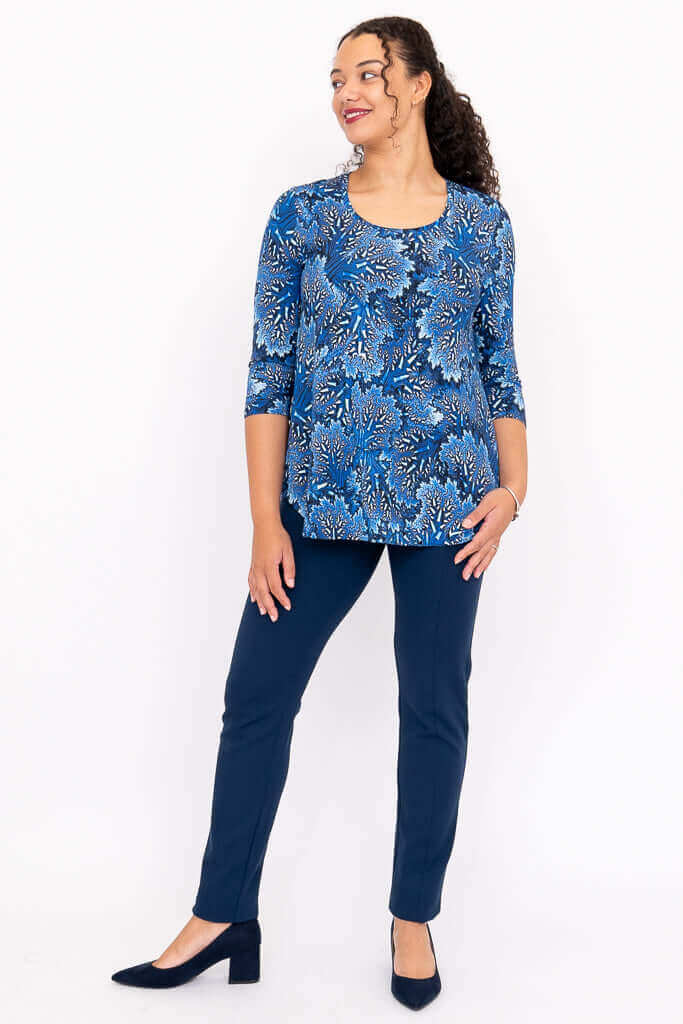Model in blue patterned 3/4 sleeve bamboo top and navy pants, angled pose