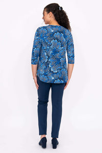 Back view of model wearing blue patterned 3/4 sleeve bamboo top and navy pants
