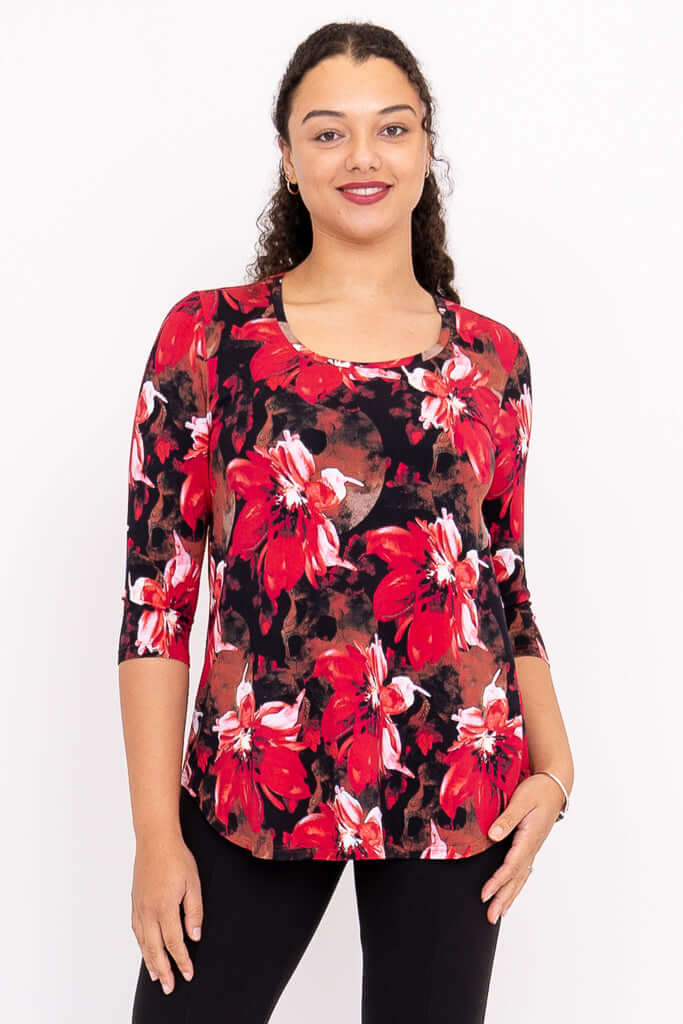 Front view of a model wearing a red floral 3/4 sleeve bamboo top