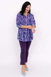 Model adjusting sleeve of the Cindy violet dragonfly blouse, 3/4 sleeve detail