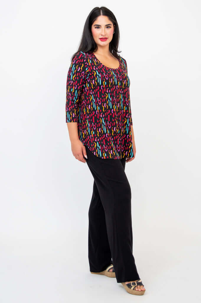 Three-quarter side view of model in Jazz 3/4 sleeve top and black wide leg pants