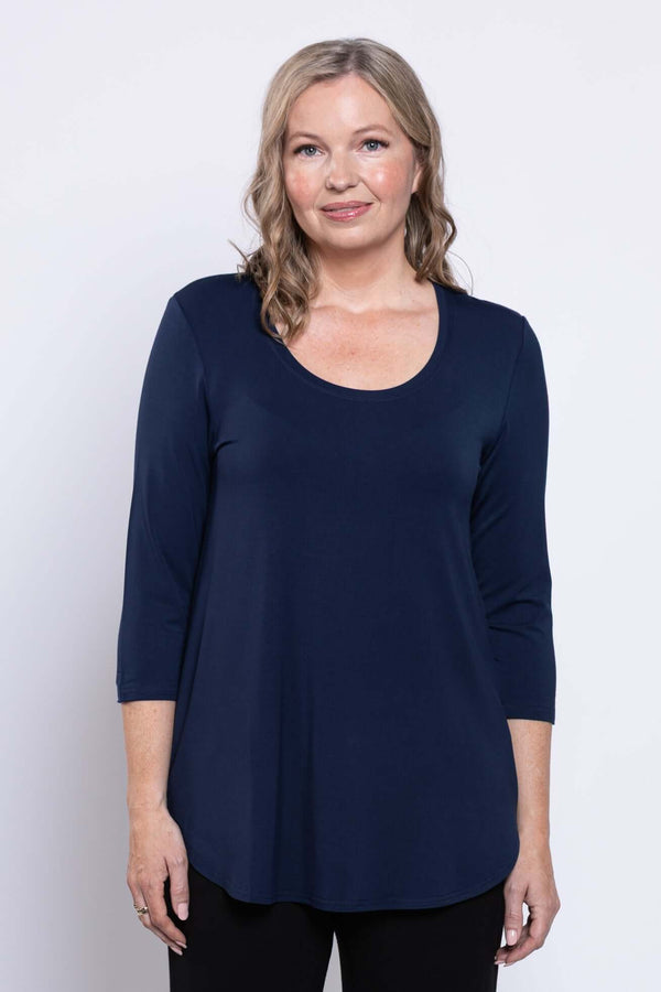 Front close-up of a woman wearing a navy 3/4 sleeve scoop neck top