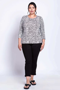 Plus size woman modeling black and white rose print 3/4 sleeve tee
