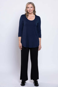 Full body shot of a woman in a navy 3/4 sleeve top and black wide leg pants