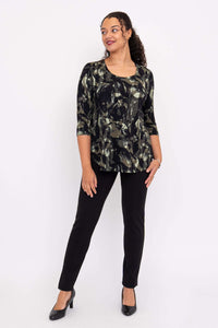 Woman looking to the side in black and olive print 3/4 sleeve bamboo top and black pants