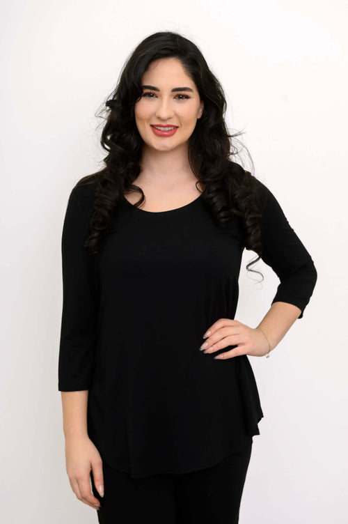 Woman wearing a black 3/4 sleeve top, front view with hand on hip