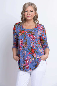 Front close view of blue floral 3/4 sleeve top with pockets