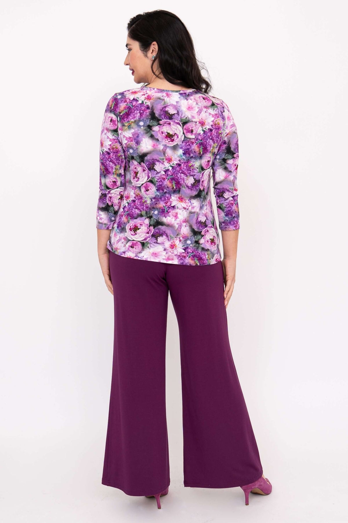Back view of woman in floral 3/4 sleeve tee and purple wide-leg pants