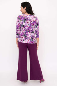 Back view of woman in floral 3/4 sleeve tee and purple wide-leg pants
