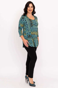 Woman showing side angle of turquoise mosaic 3/4 sleeve top with black pants