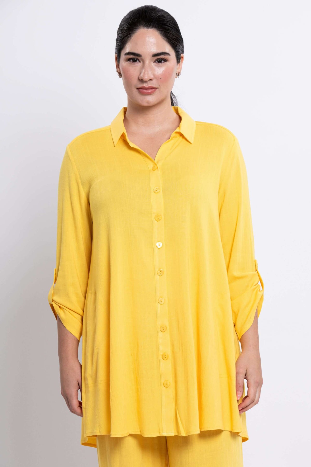 Front view of model wearing yellow oversized bamboo-linen tunic with button front and 3/4 tabbed sleeves