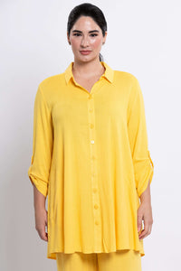 Front view of model wearing yellow oversized bamboo-linen tunic with button front and 3/4 tabbed sleeves