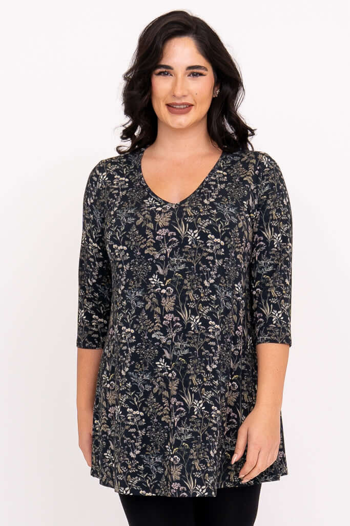 Front view of woman wearing a floral A-line bamboo tunic with 3/4 sleeves