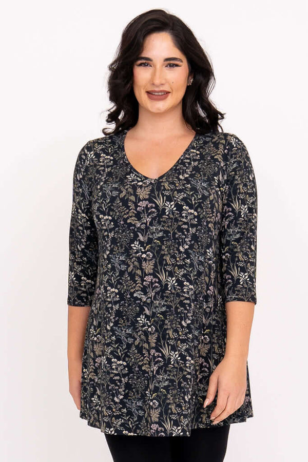 Front view of woman wearing a floral A-line bamboo tunic with 3/4 sleeves