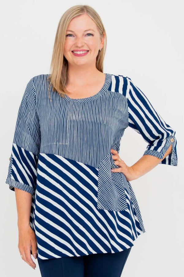 Woman wearing a navy and white striped blouse with a scoop neckline and 3/4 sleeves, front view