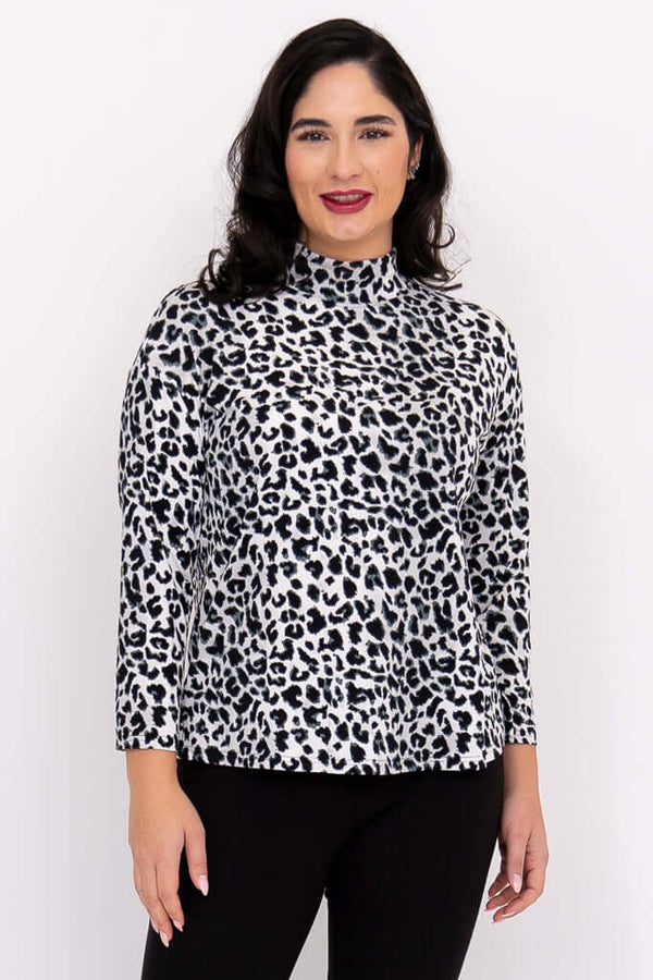 Front view of woman wearing a leopard print mock neck top with 3/4 sleeves