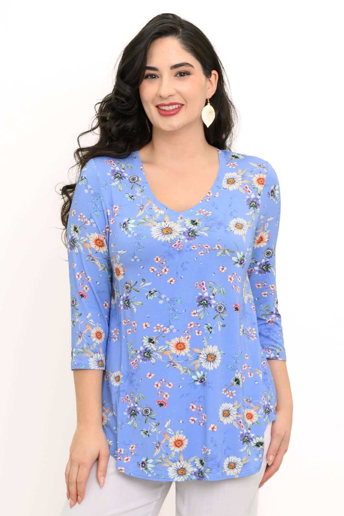 Woman wearing a blue floral V-neck top with 3/4 sleeves, front view