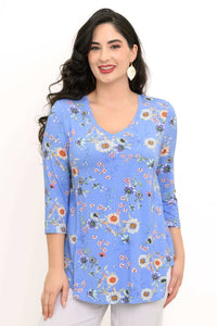 Woman wearing a blue floral V-neck top with 3/4 sleeves, front view