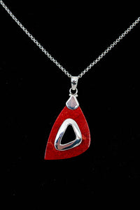 Close-up of a 925 sterling silver necklace featuring a modern red teardrop pendant