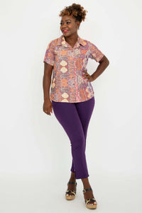 Woman in Aida Top posing with hand on hip and purple pants