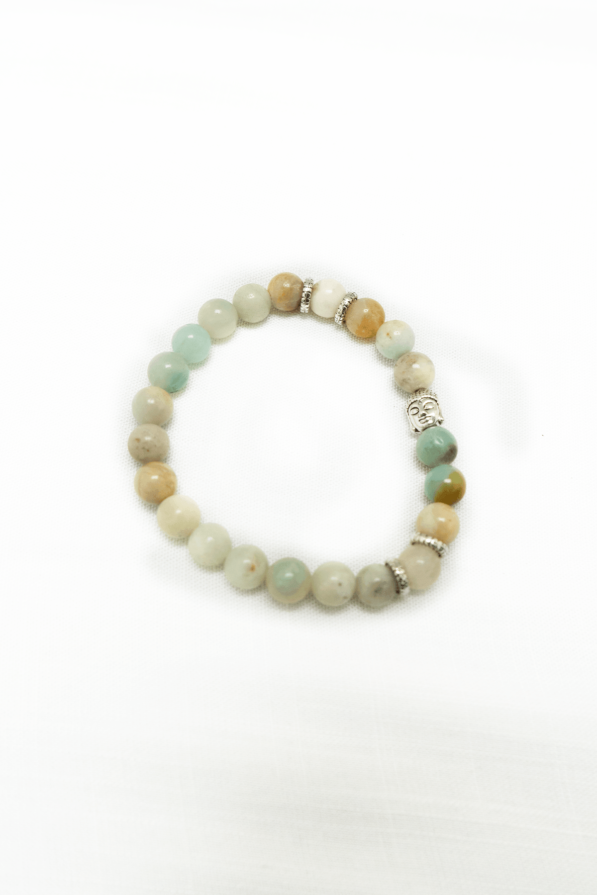 Beaded amazonite bracelet with silver accents and tranquil blue-green stones on white background