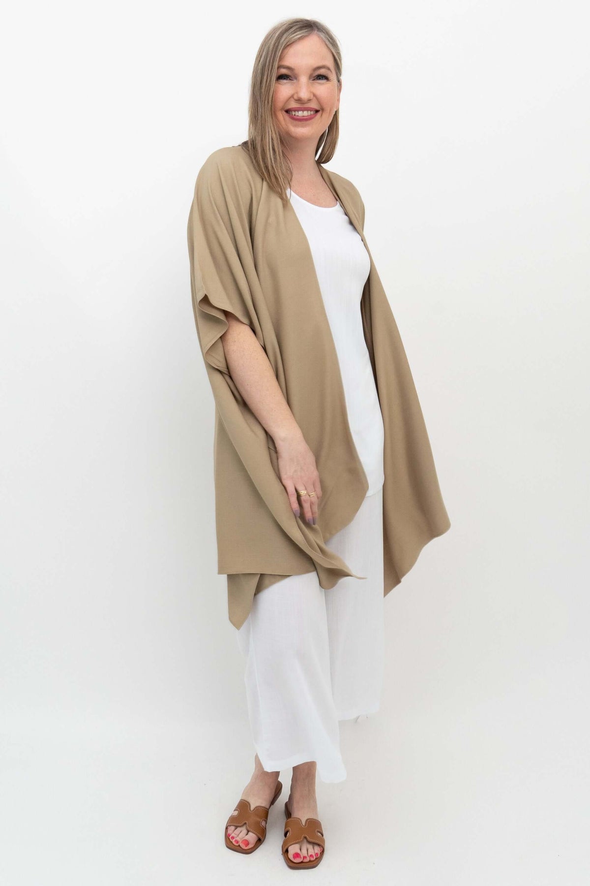 Angled front view of model in sand Darcy kimono wrap with relaxed fit