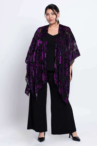 Front angled view of a woman in a black and purple velvet burnout kimono wrap
