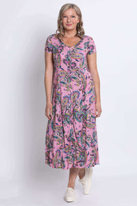 Angled front view of a woman in a pink paisley print dress with relaxed fit