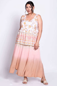 Angled front view of model in Kaya Floral Tiered Tank Top and flowy peach skirt