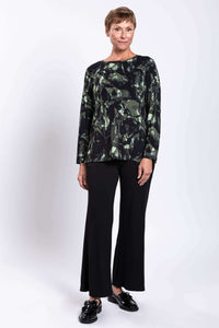 Angled front view of woman in Margie boat neck printed top with relaxed fit