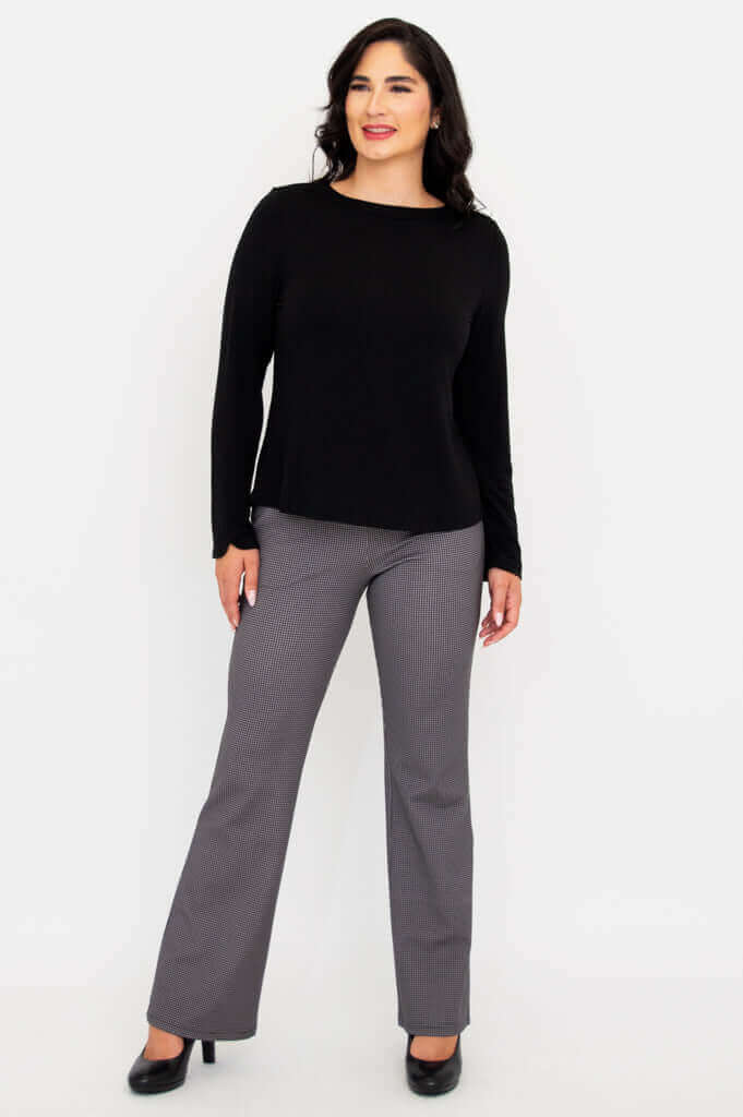Full body angled front view of woman in Mona boat neck top and check pants
