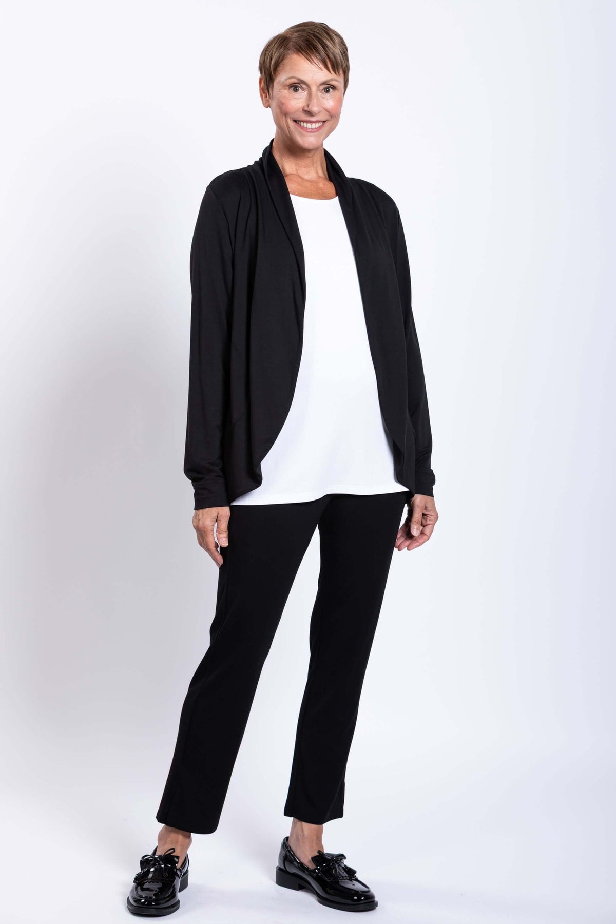 Woman modeling a black French Terry jacket and black pants, angled front view
