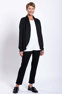 Woman modeling a black French Terry jacket and black pants, angled front view