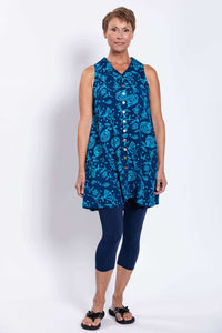 Front angled view of sleeveless blue A-line tank dress with button-up closure and summery floral print