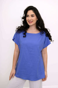 Woman smiling in a blue relaxed-fit tee with short sleeves, angled front view