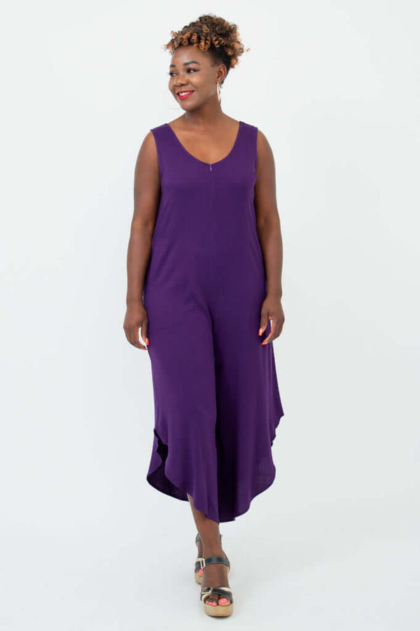 Model in purple jumpsuit walking, angled view