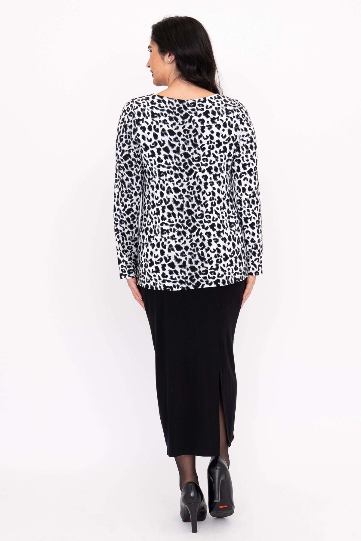 Back view of model wearing Annette leopard print long sleeve top and black skirt