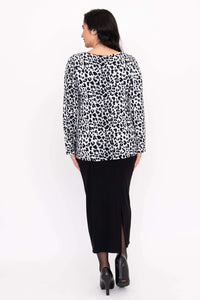 Back view of model wearing Annette leopard print long sleeve top and black skirt