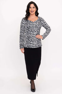 Full front view of model in Annette leopard print long sleeve top and black skirt