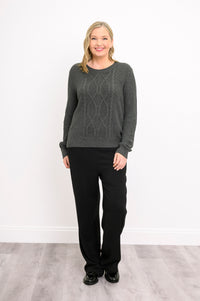 Front view of a women's graphite long-sleeve knit top, showcasing a textured plaited pattern on a model.